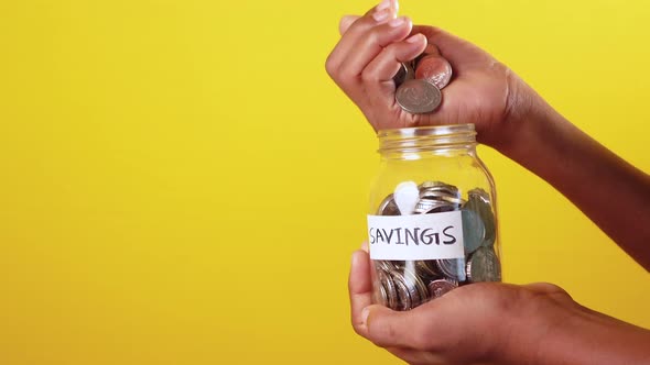 Young Man Saving Coins in a Jar White Sited