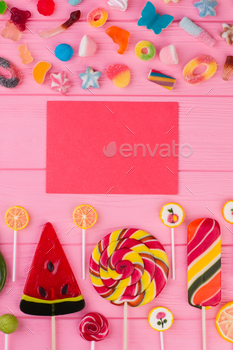  sweets on pink wooden background. Greeting card background.