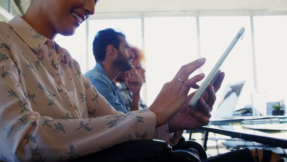 Female executive using digital tablet in office