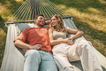 A man and a woman lying in a hammock and feeling relaxed - PhotoDune Item for Sale