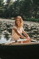 A woman sitting in a boat and oaring - PhotoDune Item for Sale