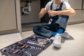 Man sitting on floor with plumbing detail in hands - PhotoDune Item for Sale