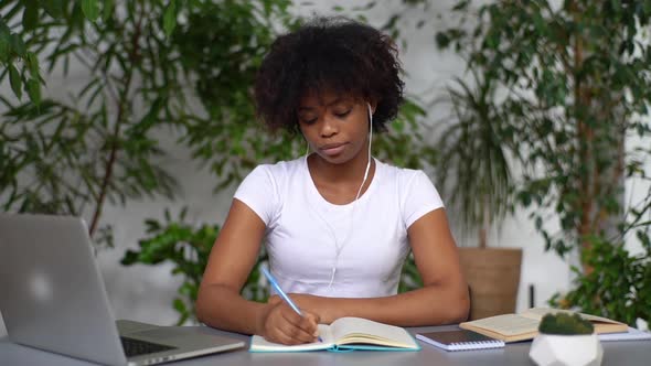 Focused Young African Female University Student Learning Subject Preparing for Exams Making Notes