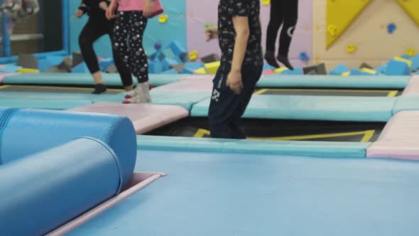 Children Jump on Trampolines in the Children's Entertainment Center