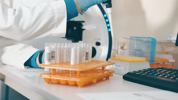 Researcher Working in a Laboratory with a Microscope Uses a Laboratory Pipette To Test Blood in Test