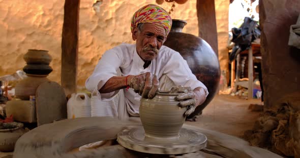 Indian Potter at Work: Throwing the Potter's Wheel and Shaping Ceramic Vessel and Clay Ware: Pot