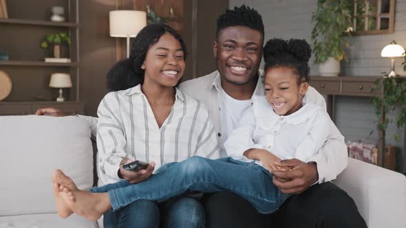 Carefree African American Father Mather Relaxing with Biracial Daughter Child Girl at Hme Holidays