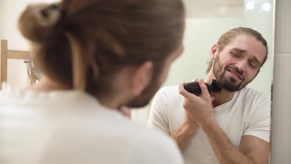 Men Face Hygiene. Man Shaving Beard And Feeling Painful
