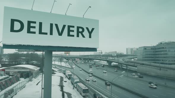 Billboard with DELIVERY Text at Urban Highway in Winter