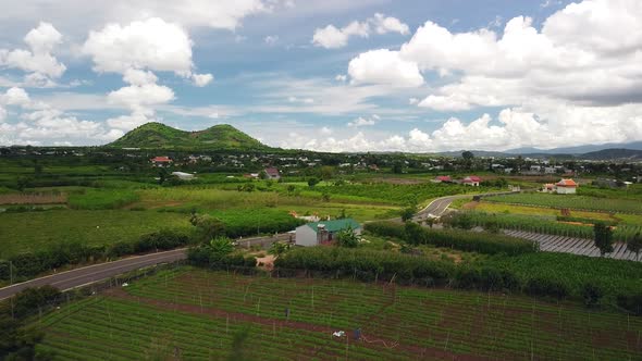 Cinematic Aerial View of Vietnam Countryside with View of Green Farms and Village.