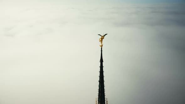 Drone Flying Around Golden St Michael Statue on Top of Mont Saint Michel Fortress Spire Glowing in