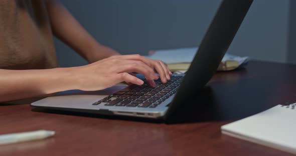 Woman work on computer at home in the evening