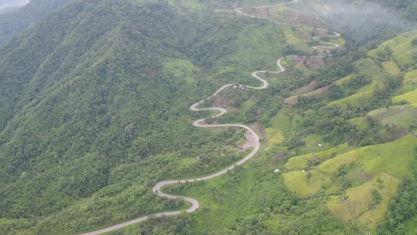 Aerial view of cars driving on curved, zigzag curve road or street on mountain hill
