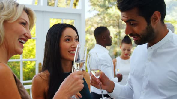 Friends toasting champagne glasses in restaurant