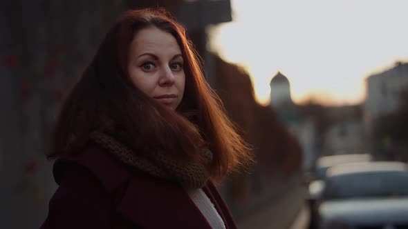 red-haired girl walking around the old town