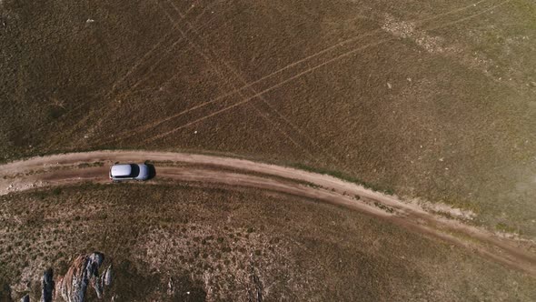 Aerial Footage Filmed with Drone of Pickup Car Riding in Steppe