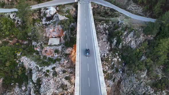 The car drives along the river aerial view 4 K