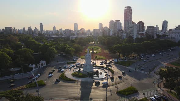 Aerial parallax shot of Libertador Avenue, Palermo woods and Buenos Aires city skyline at golden hou