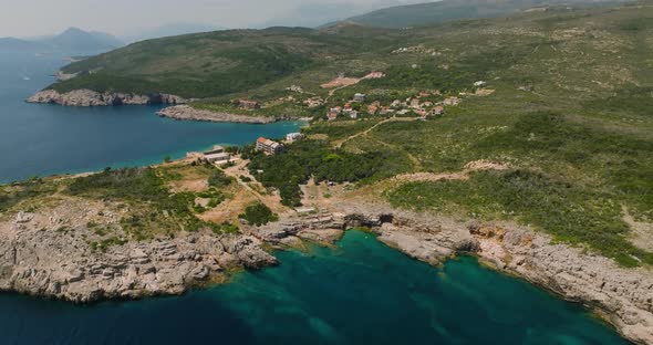 aerial view of rocky coast beach with blue water