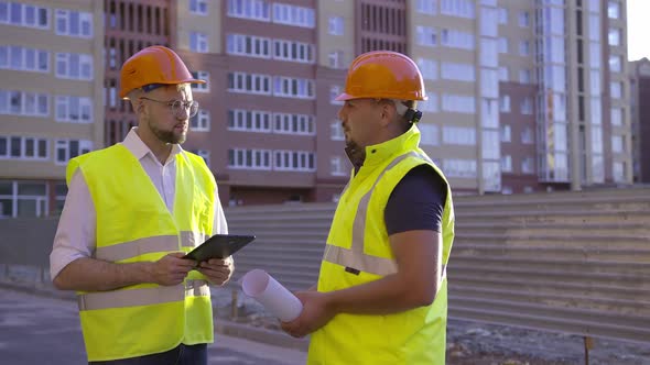 Workers Discuss Their Work Look on the Black Tablet