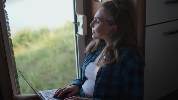 Female Freelancer Working at a Laptop and Enjoys Being in Nature While Sitting in a Car Remote Work