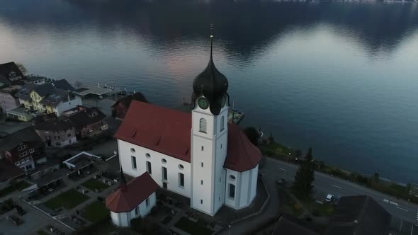 Aerial video of traditional Swiss village along Lake Lucerne, Switzerland.