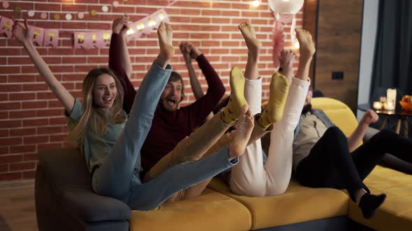 Diverse People in Casual Wear in Living Room Jumping on Sofa Together and Laughing