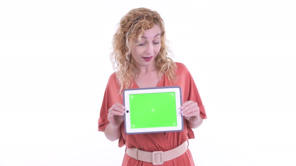 Happy Beautiful Blonde Businesswoman Thinking While Showing Digital Tablet