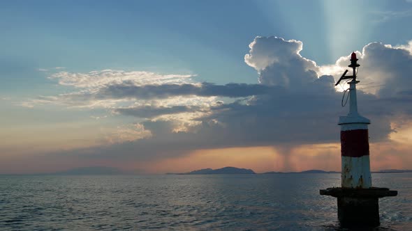 Sunset in Mesologgi Greece. Boat view of the sunset behind clouds and sea horizon.