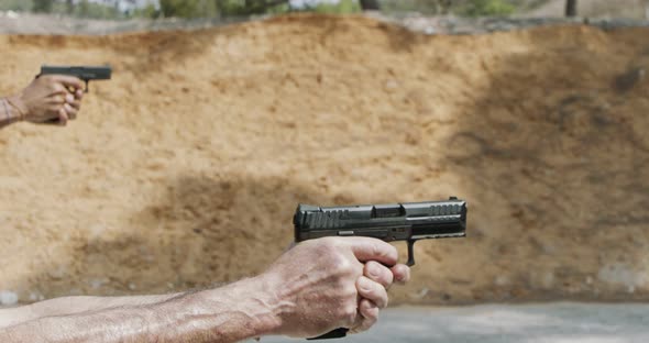 Pistol shooting bullets in slow motion footage. Hand guns in firing range