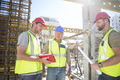 Three construction workers talking in construction site - PhotoDune Item for Sale