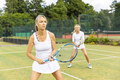 Mature women during a tennis match on grass court - PhotoDune Item for Sale
