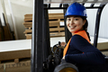 Portrait of confident female worker on forklift in factory - PhotoDune Item for Sale