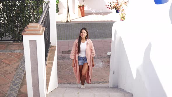 Cheerful Ethnic Lady Walking Upstairs