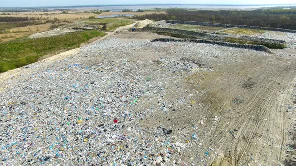 The huge garbage dump on the outskirts of the forest, view from drone