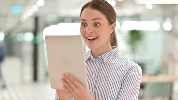 Portrait of Young Woman Celebrating Success on Tablet 