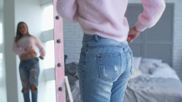 Woman Showing Successful Weight Loss with Her Jeans