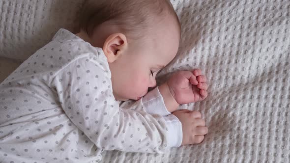 Peaceful Adorable Baby Sleeping on His Bed in a Room at Home