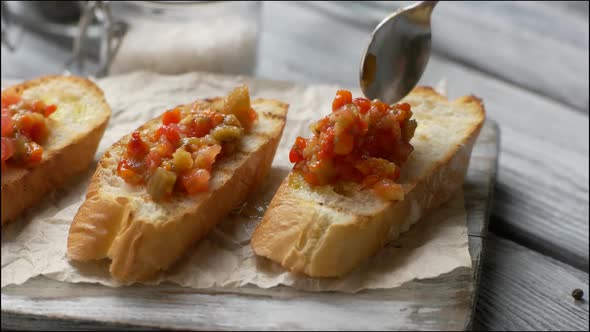 Spoon Puts Vegetables on Bread.