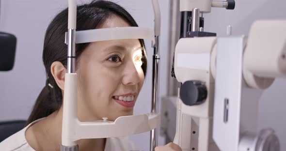 Woman do eye test at clinic