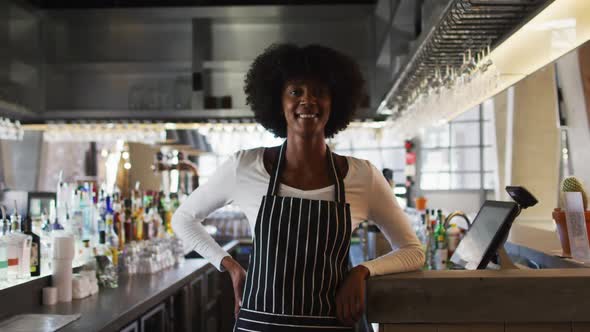 Portrait of happy african american female cafe worker looking at the camera and smiling