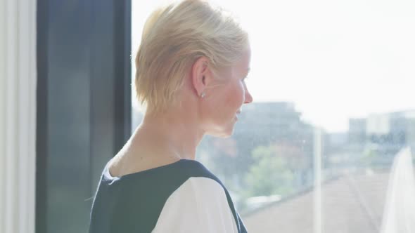 Business woman thoughtful looking through the window