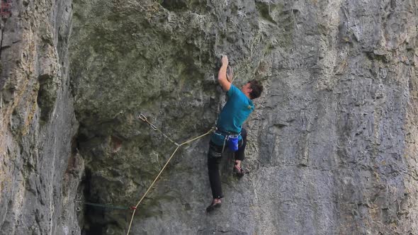 A man rock climbing up a mountain.