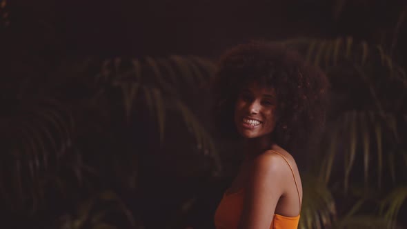 Young Dancing Woman With Hands In Afro Hair