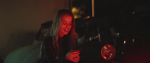 Woman smiles while texting