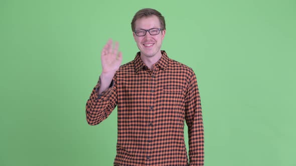 Happy Young Handsome Hipster Man Waving Hand