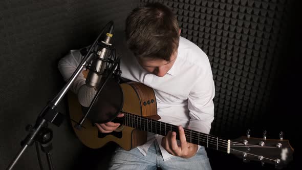 Young Musician That Is Recording New Song in a Modern Sound Studio.