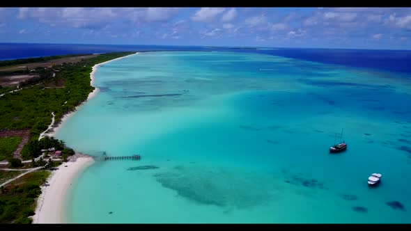 Aerial drone view tourism of marine coast beach vacation by shallow ocean with white sandy backgroun