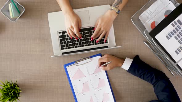 Top View Business Partners Working at Office Desk