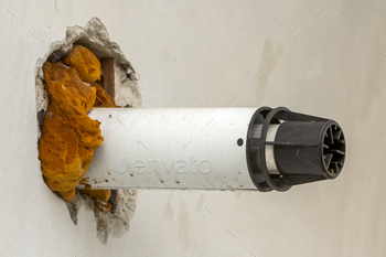 rigid polyurethane styrofoam insulation and fixed with foam ventilation pipe. Modern technology, renovation, energy saving, professional job concept.